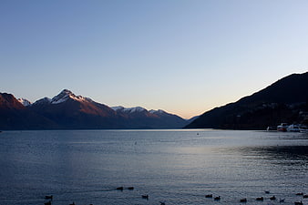 Serene Lake Landscape with Snow-Capped Mountains at Sunset