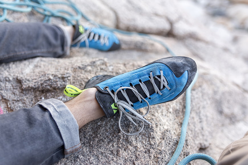 Blue Rock Climbing Shoes on Granite Rock Face