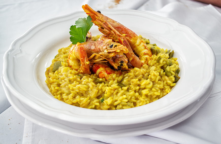 Saffron Risotto with Shrimp and Parsley in White Ceramic Bowl