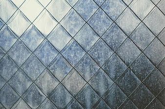 Textured blue diamond pattern glass background