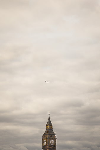 Big Ben Clock Tower with Airplane in Cloudy Sky