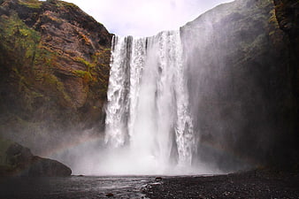 Majestic Skógafoss Waterfall in Iceland with Mist and Rainbow