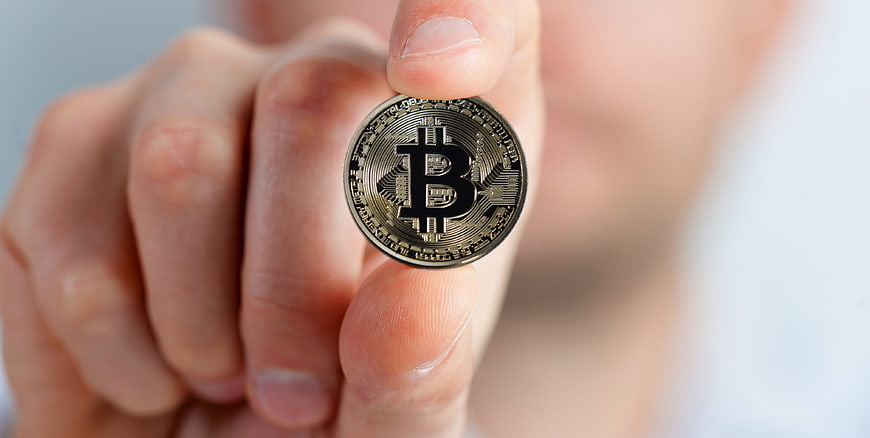 Hand Holding Physical Bitcoin Coin Close Up