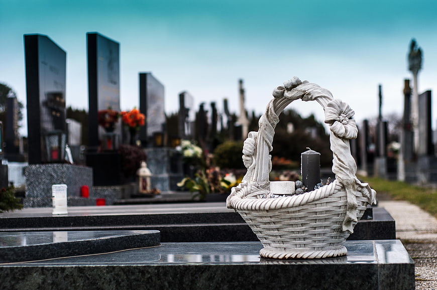 White Stone Basket Candle Holder on Cemetery Tombstone