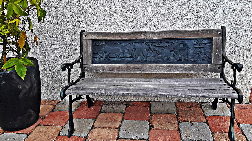 Rustic Wooden Bench with Farm Animal Relief on Patio