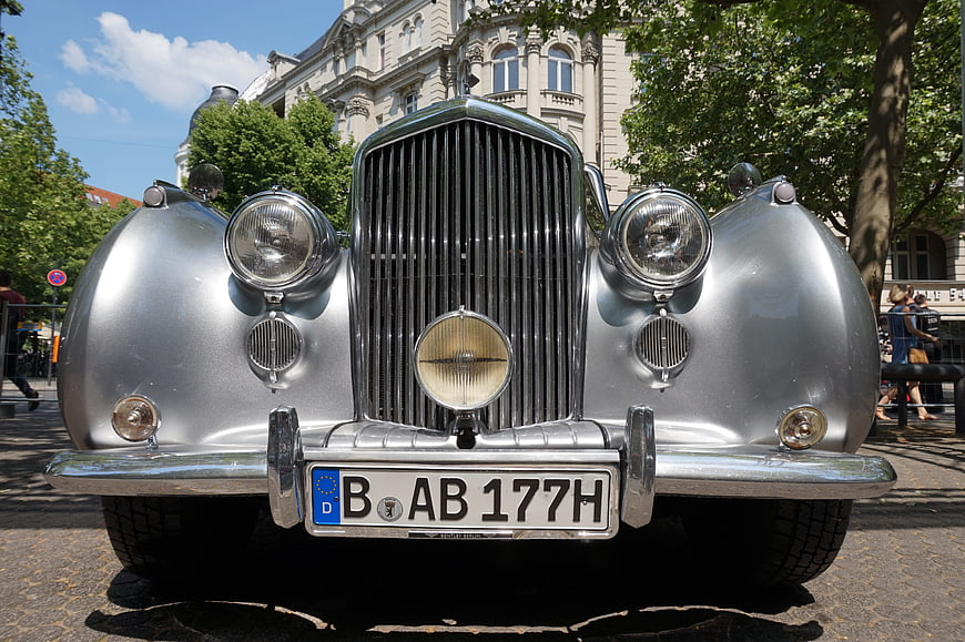 Front view of silver vintage classic car with chrome grille