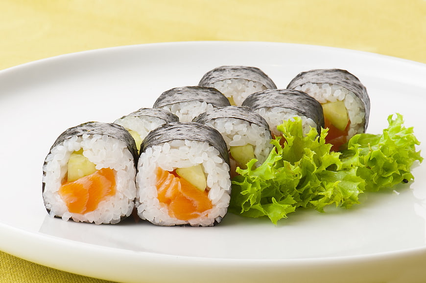 Fresh Salmon and Cucumber Sushi Rolls on White Plate