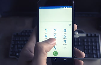 Hand Dialing Number On Smartphone Keypad In Office