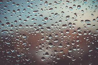 Raindrops on Glass Window with Blurred Background
