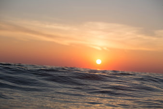 Serene Sunset Over Ocean Waves at Dusk