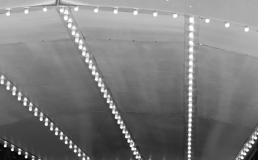 Abstract black and white ceiling with geometric light patterns