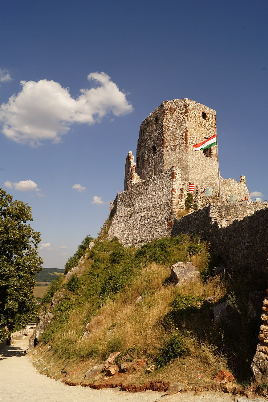 Historic Stone Castle Ruins With Hungarian Flag On Hilltop