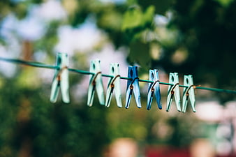 Colorful plastic clothespins on a clothesline outdoors