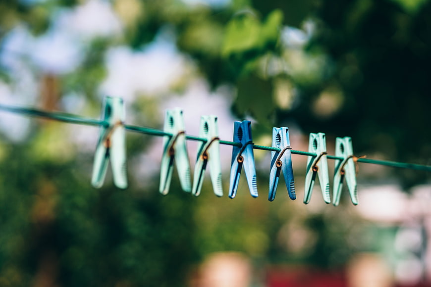 Colorful plastic clothespins on a clothesline outdoors