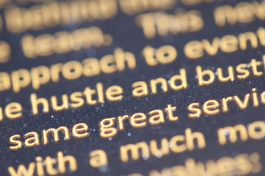 Close-up of Gold Foil Text on Black Background