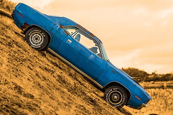 Vintage Blue Plymouth Barracuda on Grassy Hill
