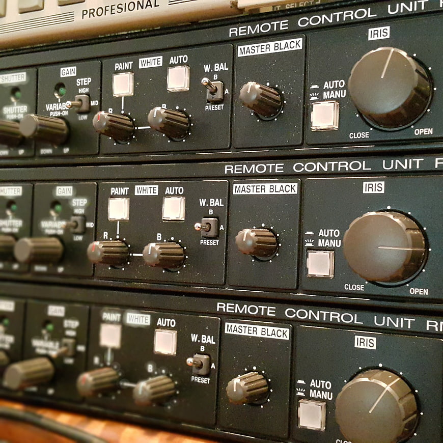Close-up of stacked professional video camera remote control units