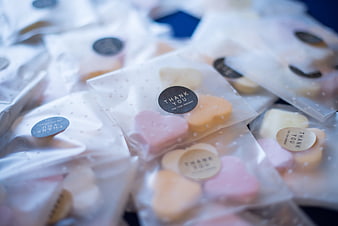 Heart-shaped candies in clear bags with thank you stickers