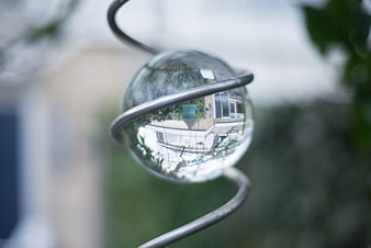 Crystal Ball Reflecting Upside Down House in Garden