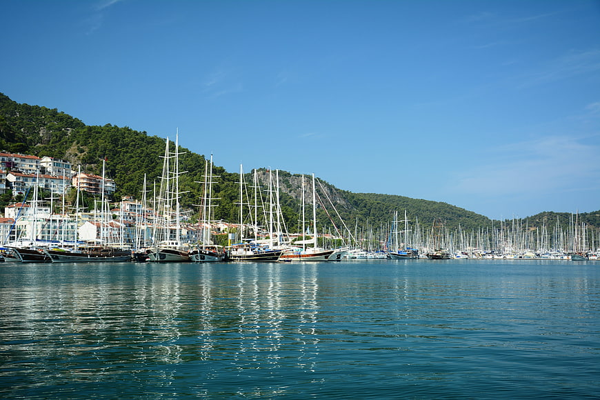 Panoramic view of sailboats in a sunny coastal harbor