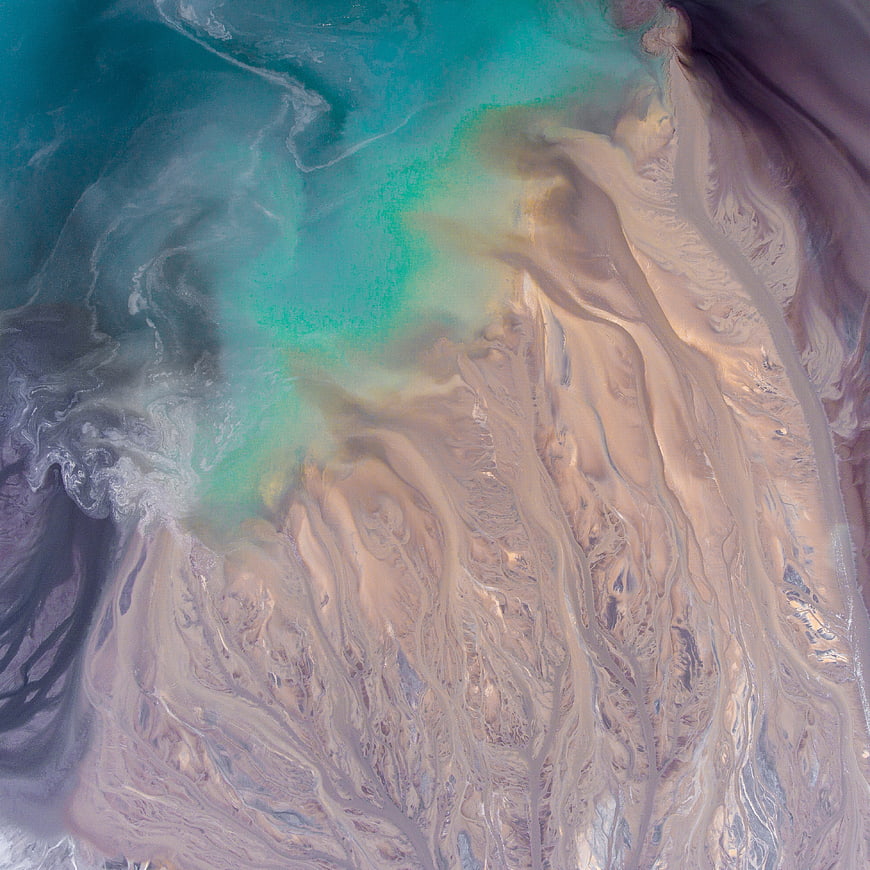 Abstract Aerial View of Turquoise Water and Sandy Sediment Swirls