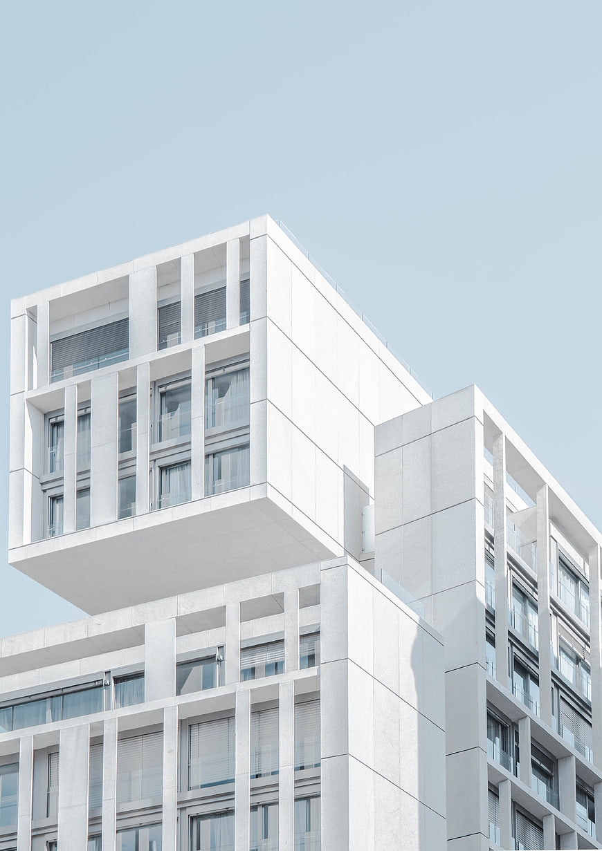 Modern White Geometric Architecture Against Blue Sky