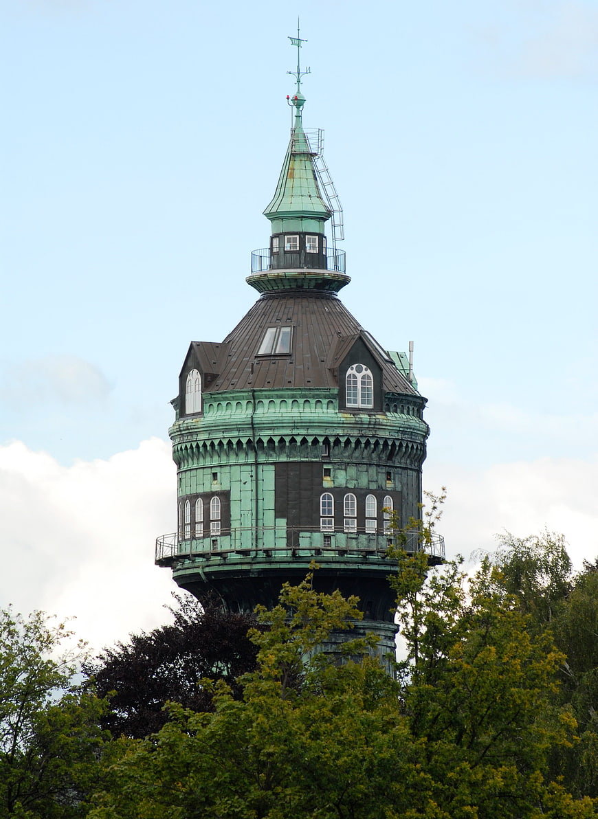 Historic green copper water tower in Hamburg against blue sky