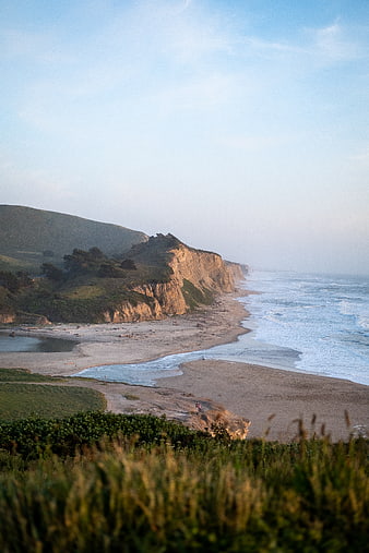 Scenic Coastal Cliff Landscape with Ocean Waves and Sandy Beach