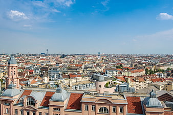 Panoramic Vienna Cityscape with Red Roofs and Blue Sky