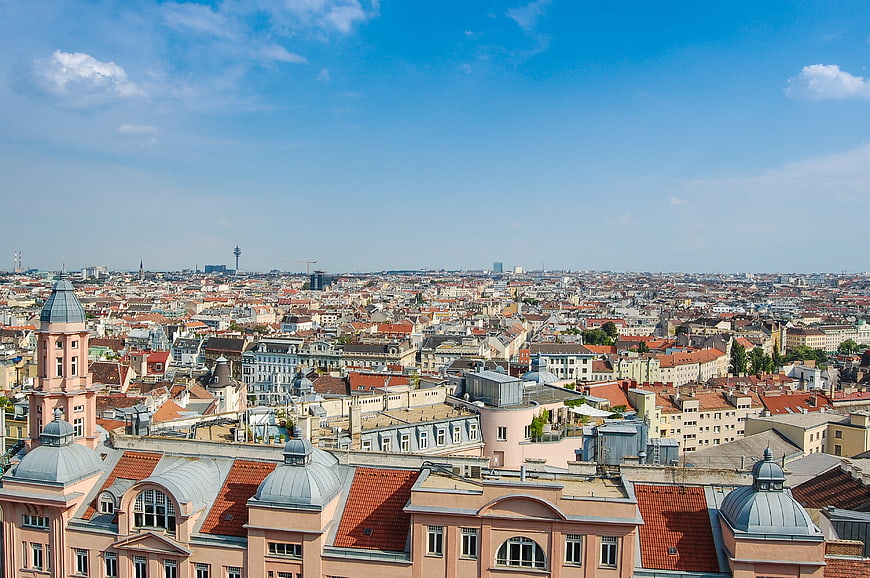 Panoramic Vienna Cityscape with Red Roofs and Blue Sky