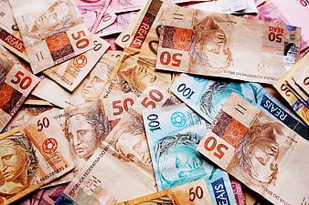 Scattered Brazilian Real Banknotes Including 50 and 100 Reais