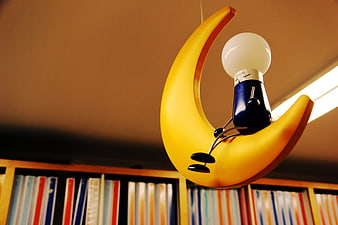 Yellow crescent moon lamp with light bulb figure