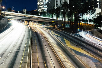 Night highway traffic light trails cityscape