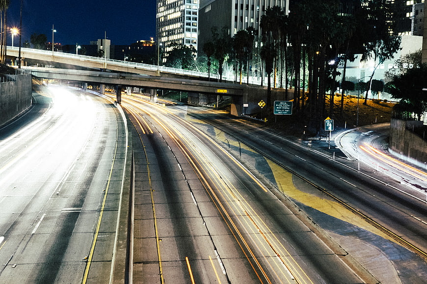 Night highway traffic light trails cityscape