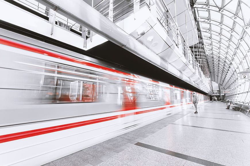 Motion Blur of Red and White Train in Modern Station