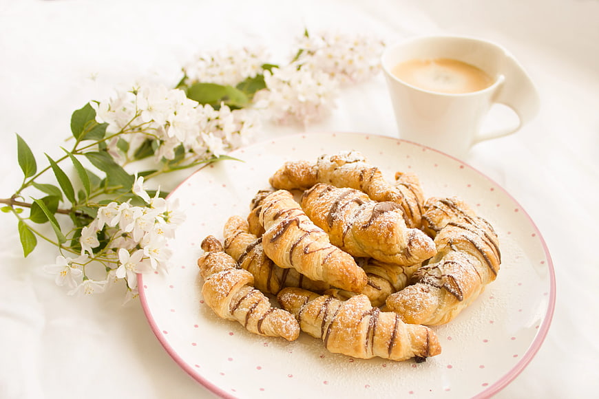 Fresh Croissants with Coffee and Spring Flowers