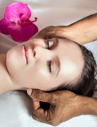 Woman Receiving Head Massage With Orchid