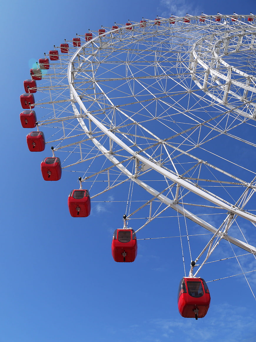 Red Ferris Wheel Against Blue Sky