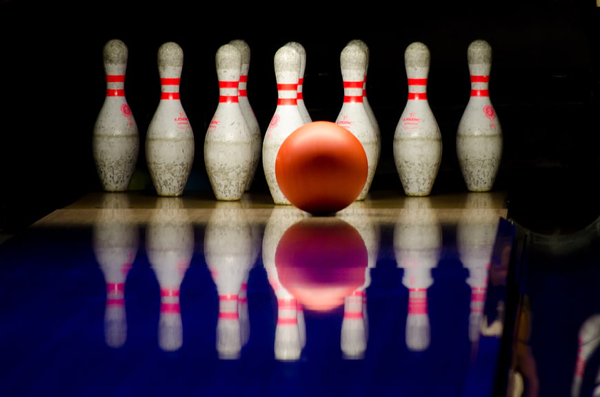 Orange Bowling Ball and Pins on Lane
