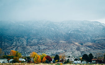 Autumn landscape with colorful trees and misty mountains