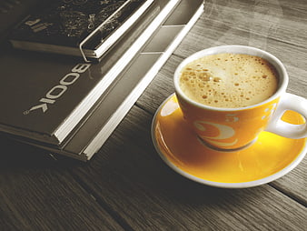 Yellow Coffee Cup and Books on Wooden Table