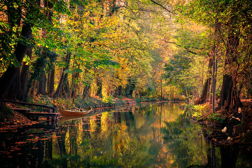 Autumnal Spreewald Canal with Wooden Boat and Reflections