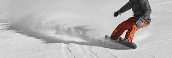 Snowboarder Carving Through Powder Snow With Orange Pants