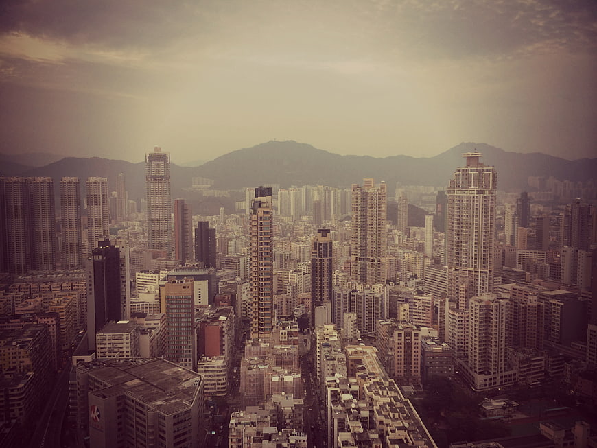 Aerial View of Hong Kong Cityscape with Skyscrapers and Mountains