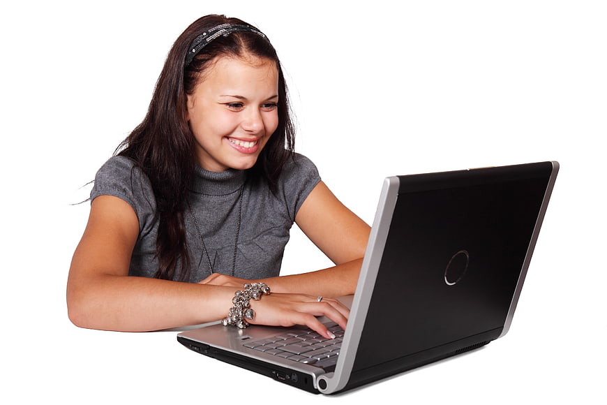 Smiling Young Woman Using Laptop on White Background