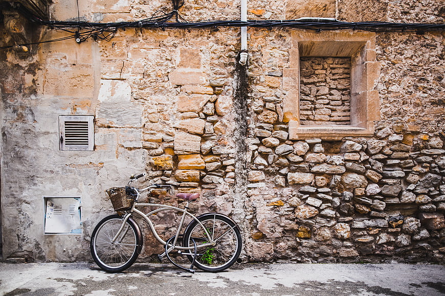 Vintage Bicycle Leaning Against Old Stone Wall