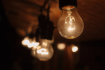 Vintage Edison Light Bulb Hanging in Dark Room