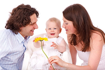 Happy family with baby holding yellow flower on white background