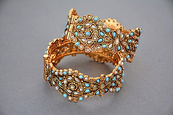 Antique Gold Bangle With Blue And Pearl Gemstone Inlay On Gray Background