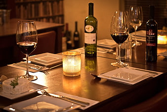 Romantic candlelit dinner table with wine and cheese